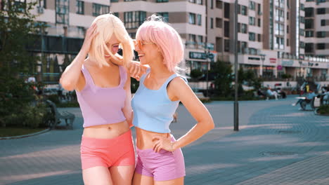 two happy women in pastel outfits