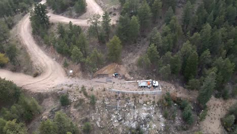 rotating drone footage of house construction in a rural mountain location