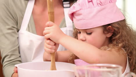 Mother-and-daughter-preparing-dough-together