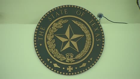 state of texas criminal justice seal on wall of court room in fort worth courthouse above judge and jury panel