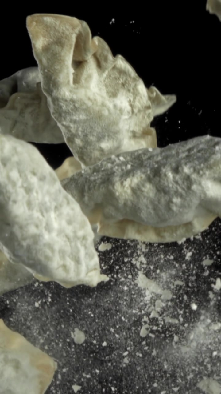 Raw Dumplings Covered in Flour Falling in Slow Motion