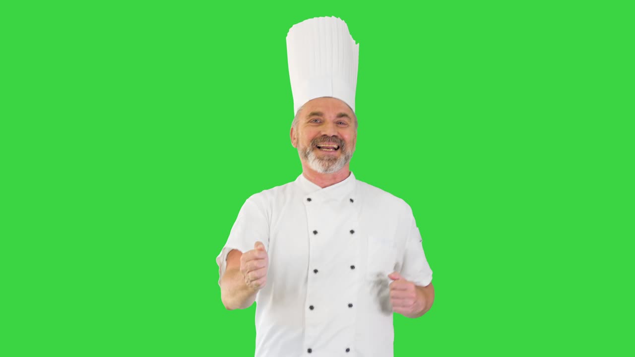 Mature chef with beard and in white uniform dancing on a Green Screen, Chroma Key