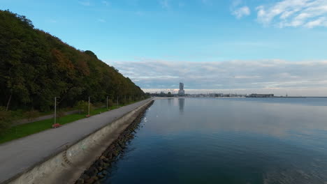 aerial flying over calm waters in seaside boulevard of gdynia