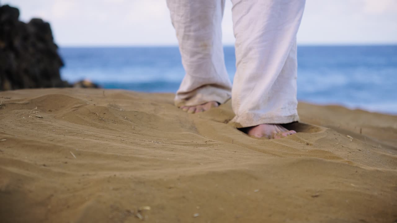Bare feet sink into warm golden sand as gentle ocean breezes move through the coastal air, evoking calm, grounding, and connection with nature’s rhythm