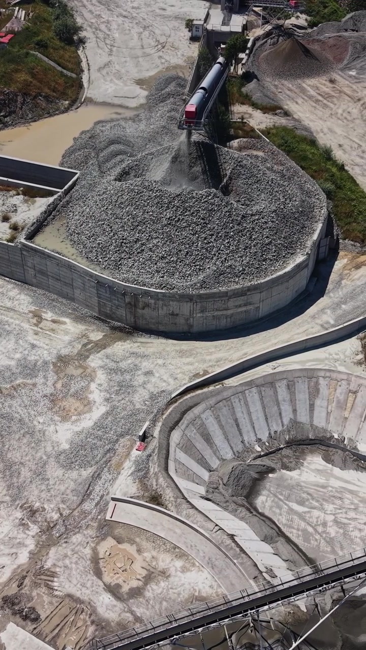 Construction site with machinery and gravel processing in daytime