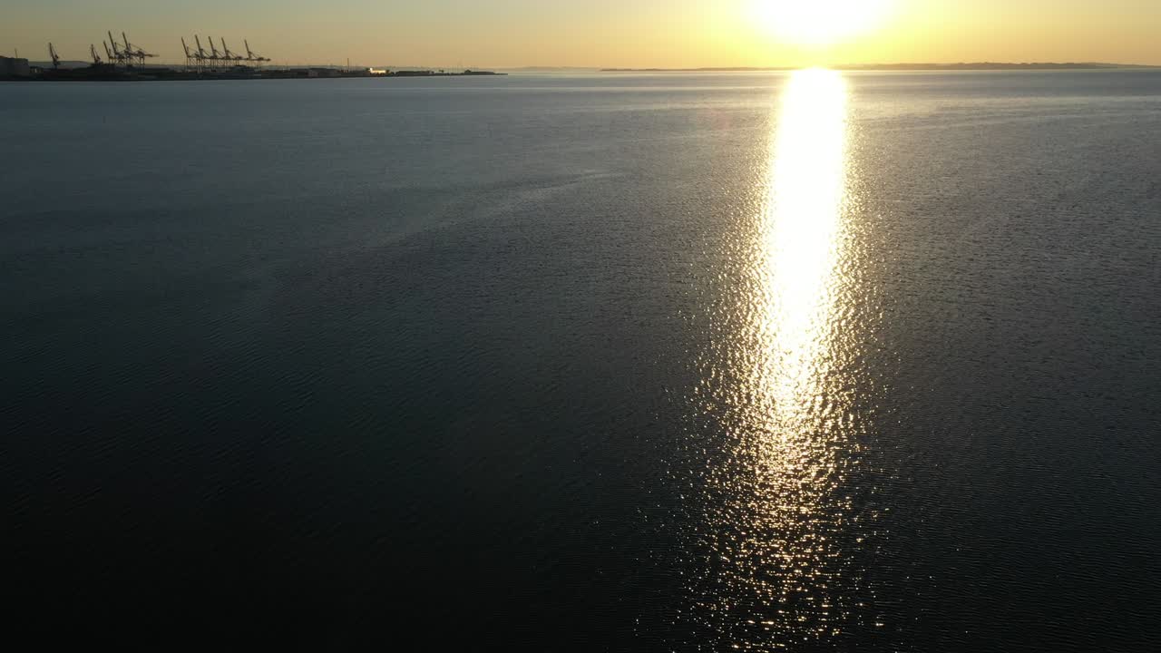 Drone Shot with Tranquil Ocean Waters, Sunlight Reflection and Row of Sailboats