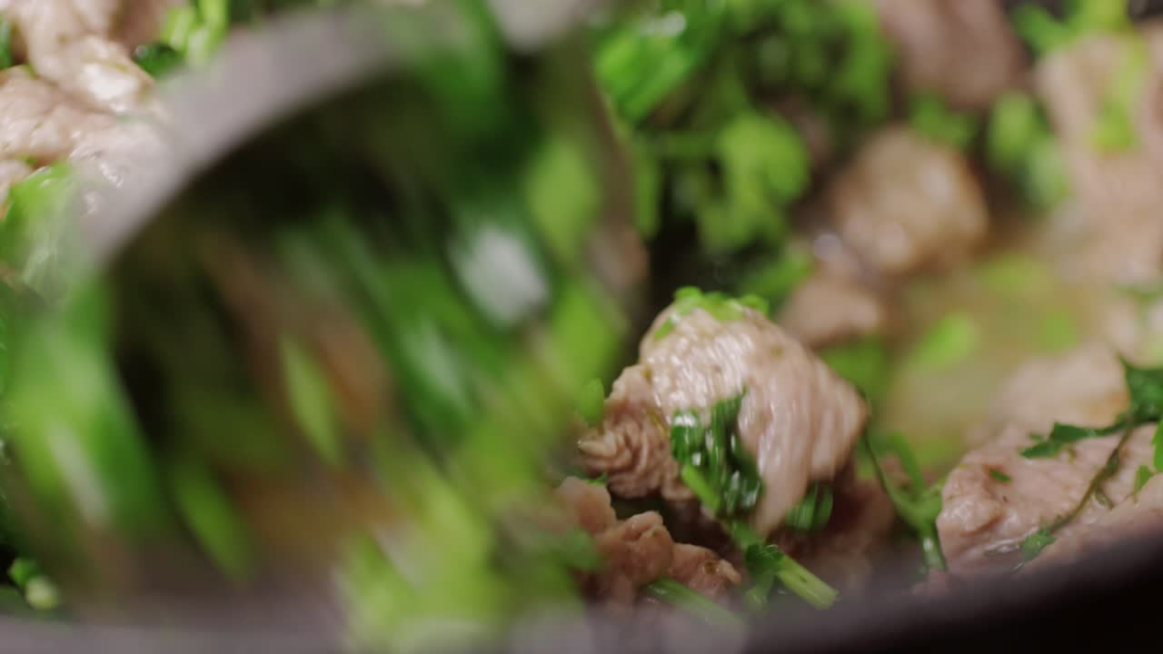 Chicken or pork stew with red and green pepper onion, and spices cooking in a frying pan. Traditional mexican cuisine, tacos preparation, ragout.