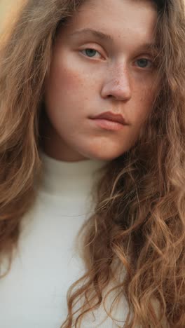 close-up portrait of a young woman with curly hair