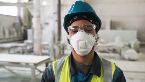 Man-wearing-protective-gear-in-factory