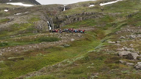 Group-of-adventure-hikers-standing-on-scenic-slope-of-Hólmatindur-in-Iceland