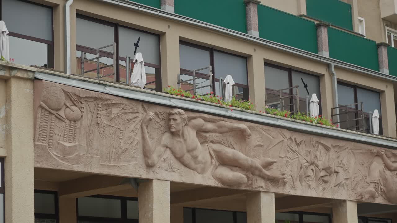 Socialist realism sculpture architecture on apartment building facade