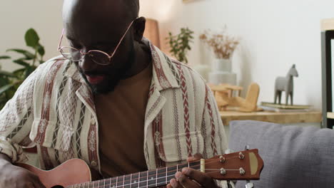 man playing ukulele