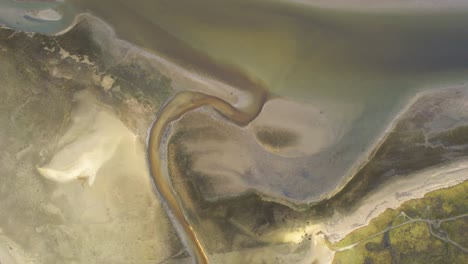 aerial drone view of land formation in texel wadden sea island mudflats, netherlands