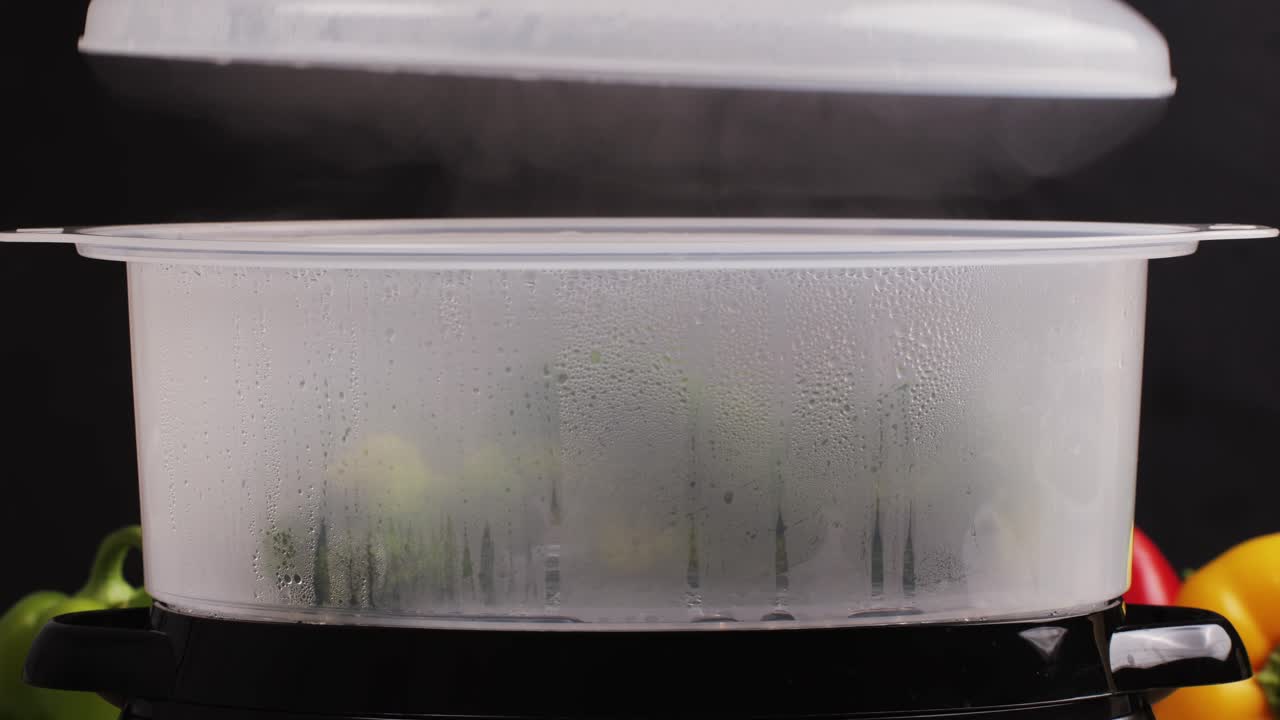 Mixed vegetables, carrots, broccoli, and cauliflower in a food double boiler steamer basket in a stainless steel pot, healthy diet cooking method preserving minerals, vitamins and flavor