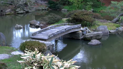 A-footbridge-spanning-a-Japanese-koi-pond