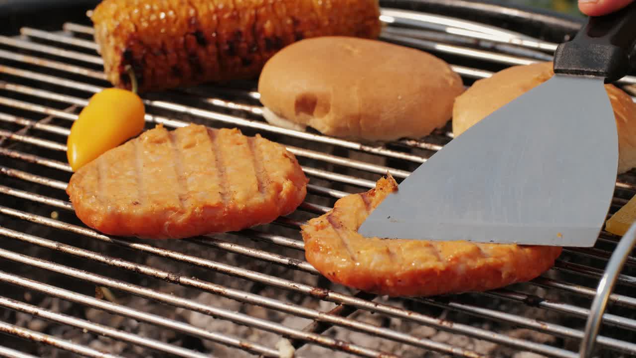 Veggie orange burger on grill, carrot and oats burger with corn and yellow pepper, vegetarian food barbeque, potato grill burger.