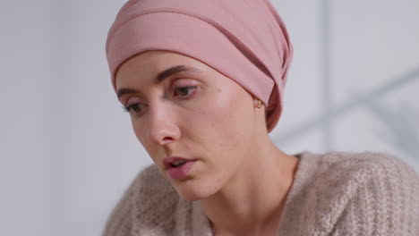 close up of serious young woman patient wearing headscarf undergoing chemotherapy treatment for breast cancer meeting with oncologist or doctor in hospital 5