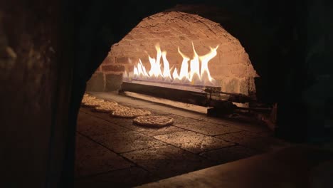 bread inside the oven,removing bread from brick oven,pitta bread,turkish pizza pita inside the oven