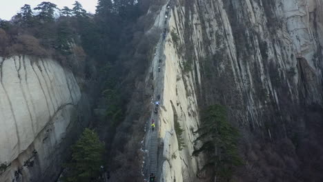 tourists climb knife edge granite steps high on mt huashan in china