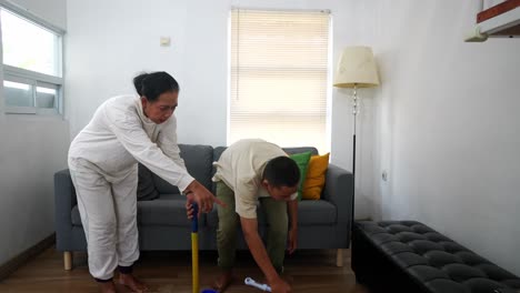 man and woman cleaning floor together