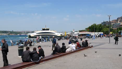 people sitting on a bench by the water in istanbul, turkey