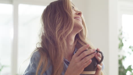 an-attractive-young-woman-enjoying-a-warm-beverage