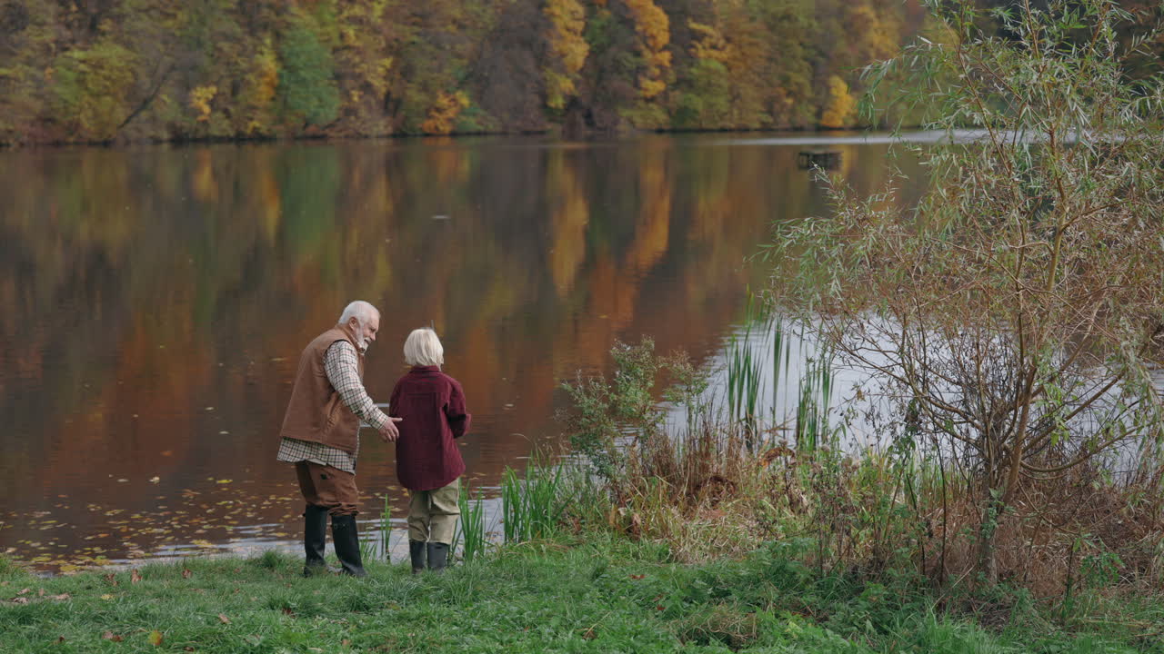 Elderly couple by a lake in autumn