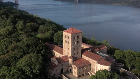 settling aerial clip of the cloisters museum on the bank of the hudson river in nyc in crispy sunrise light