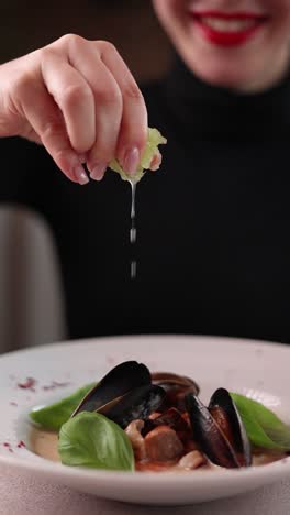 woman enjoying a delicious seafood stew