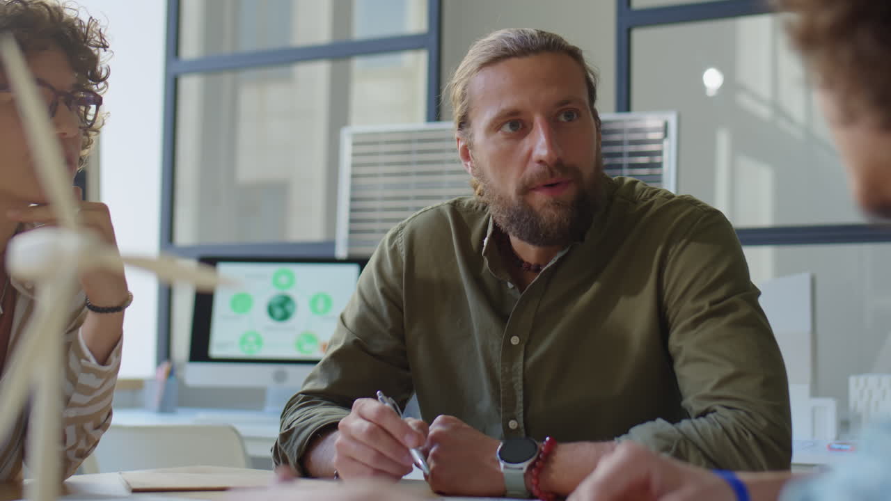 Engineer Discussing Renewable Energy Project with Team