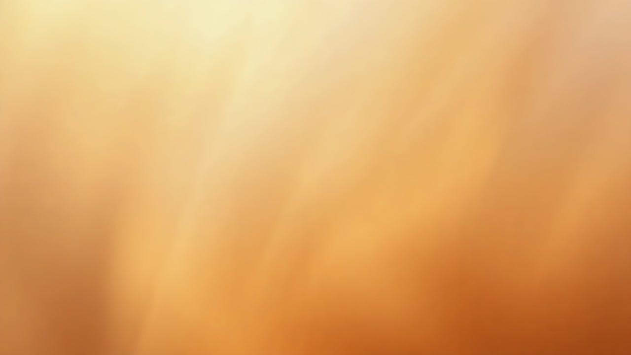 Contacting finger moving across camera lens at extreme close-up, creating warm blurred texture