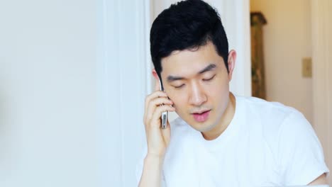 man talking on mobile phone at home 4k