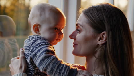 mother and baby tender moments at golden hour