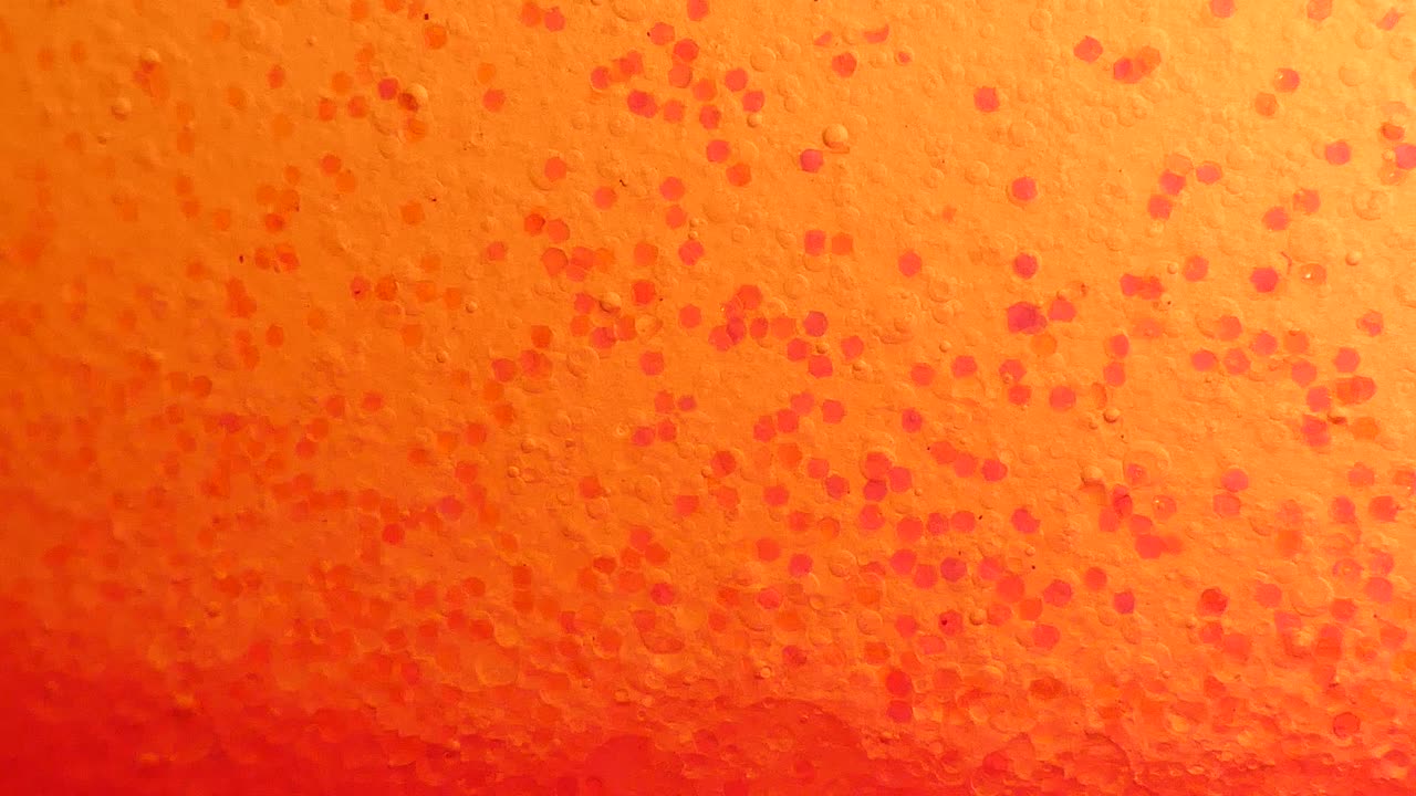 Sfondo con bolle d'olio rosa e glitter.