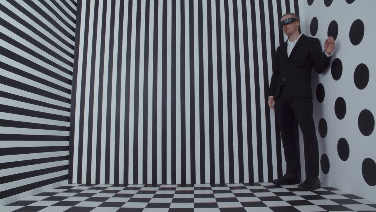 Man in VR headset, black and white optical illusion studio setting