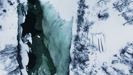 Aerial-shot-facing-down-showing-tranquil-icy-lake-in-northern-Sweden