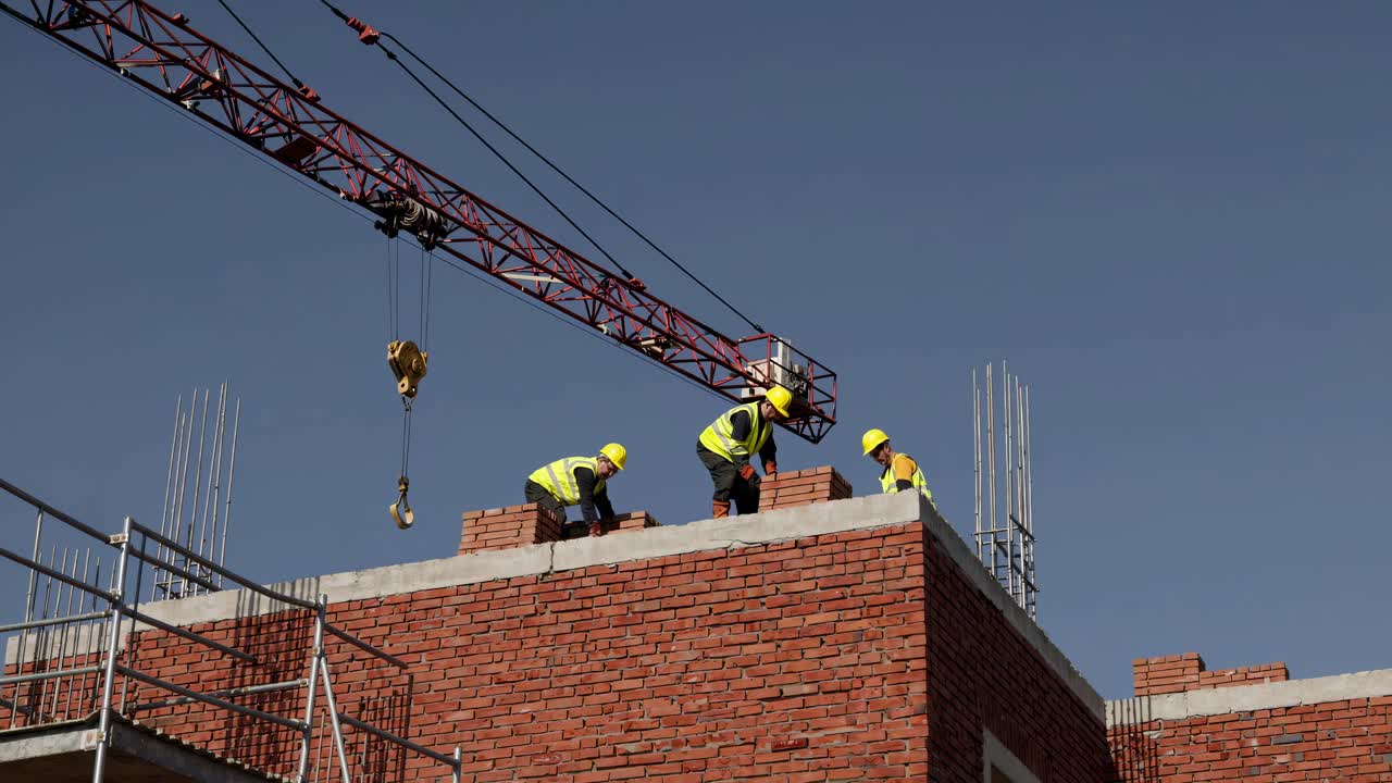 Construction Workers Laying Bricks
