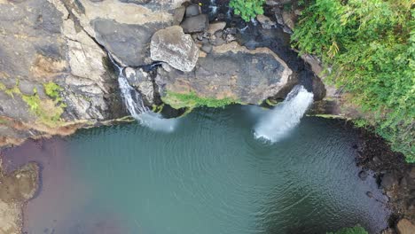 aerial view of double waterfall in a lush forest