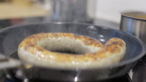 medister sausage fried in a pan at a high temperature