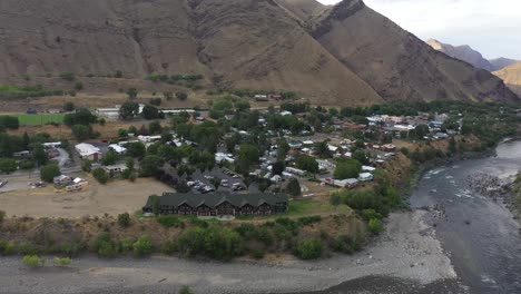 aerial view of a river town nestled in a mountain valley