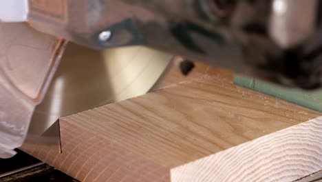 worker sawing a wood board with a circular saw. close-up hands.