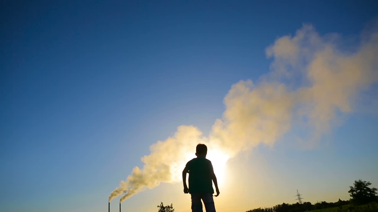 Boy Throwing Paper Plane. Happy smilling boy throwing paper airplane in green grass