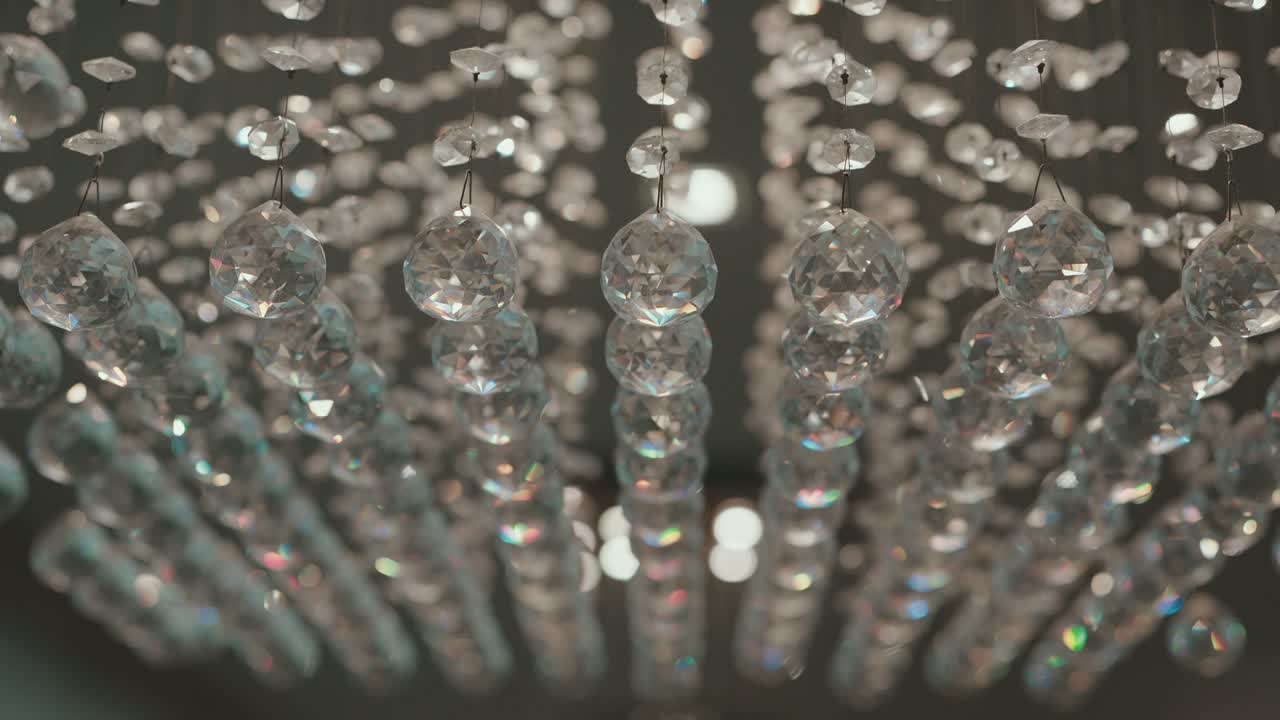 Close up of sparkling crystal chandelier strands in soft light