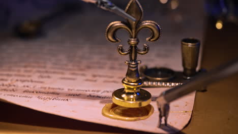 Da Vinci surgical equipment puts a seal with a metal stamp on the letter. Close up. Blurred dark background with switched on lights.