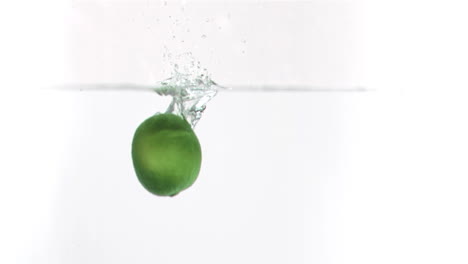 Lime-falling-into-water-in-super-slow-motion