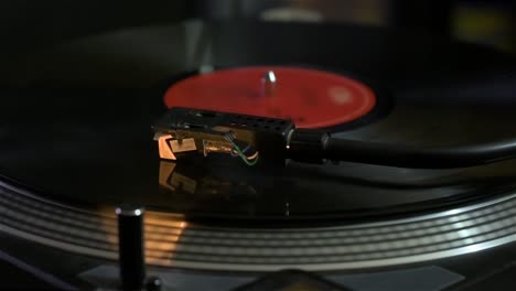 detail of record player playing a song. turntable