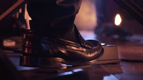 close up of a foot stepping on a piano pedal in a concert