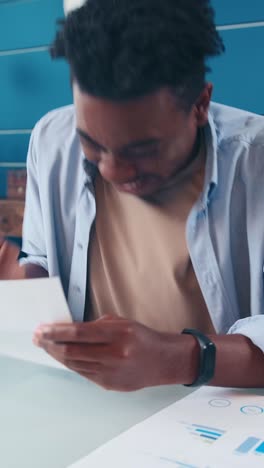engaging moment of reflection as a man examines a heartfelt letter indoors