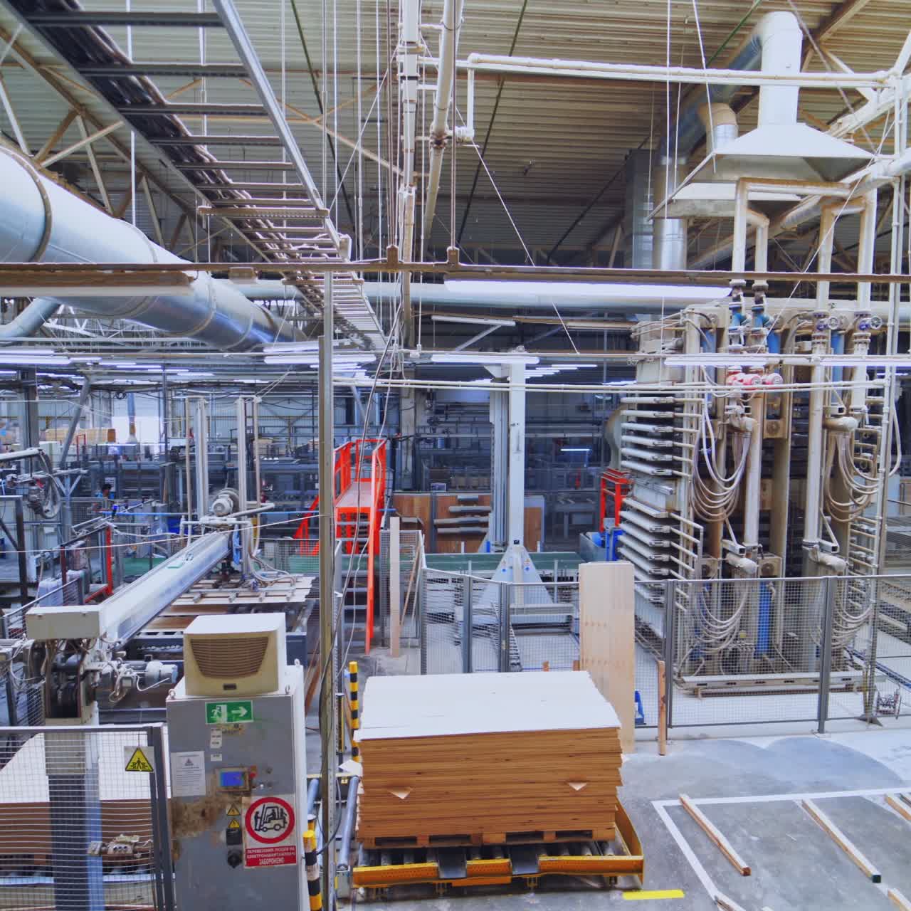 Modernized factory interior. Manufacture of furniture. High-tech automated machinery for production of wooden furniture.