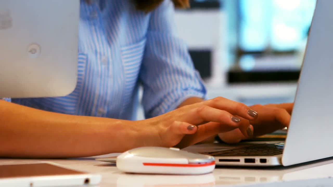 Business executive using laptop at desk